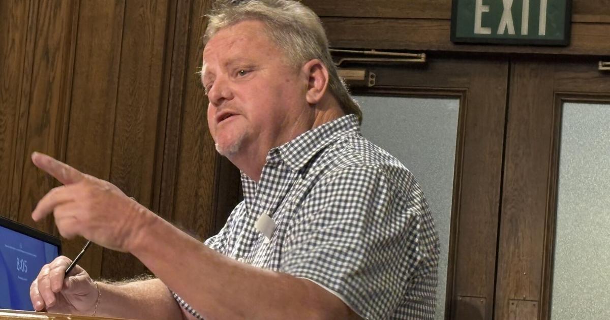 Mike Perdue speaking at the public microphone during a Guilford County Board of Commissioners meeting.